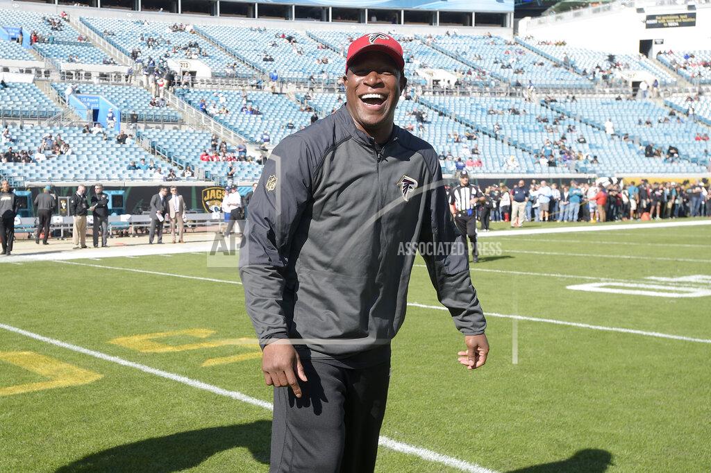Phelan M. Ebenhack FILE - In this Dec. 20, 2015, file photo, Atlanta Falcons assistant head coach Raheem Morris watches warmups before an NFL football game against the Jacksonville Jaguars in Jacksonville, Fla. The Atlanta Falcons have named defensive coordinator Raheem Morris interim head coach after firing Dan Quinn. Morris is in his sixth season with the Falcons and his first season as defensive coordinator. (AP Photo/Phelan M. Ebenhack, File