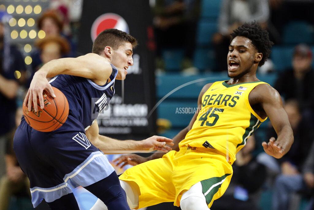 Gerry Broome Baylor guard Davion Mitchell (45) guards Villanova guard Collin Gillespie (2) during the first half of an NCAA college basketball championship game at the Myrtle Beach Invitational in Conway, S.C., Sunday, Nov. 24, 2019. (AP Photo/Gerry Broome)