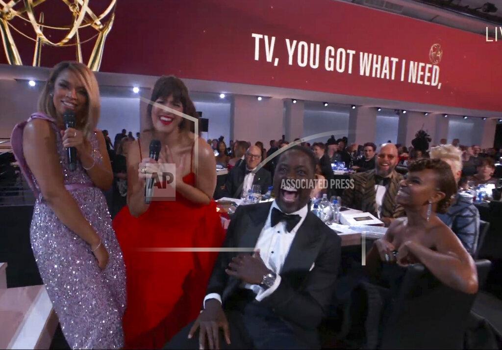 Uncredited In this video grab issued Sunday, Sept. 19, 2021, by the Television Academy, Susan Kelechi Watson, left, and Mandy Moore, second from left, perform during the opening number of the Primetime Emmy Awards. (Television Academy via AP)