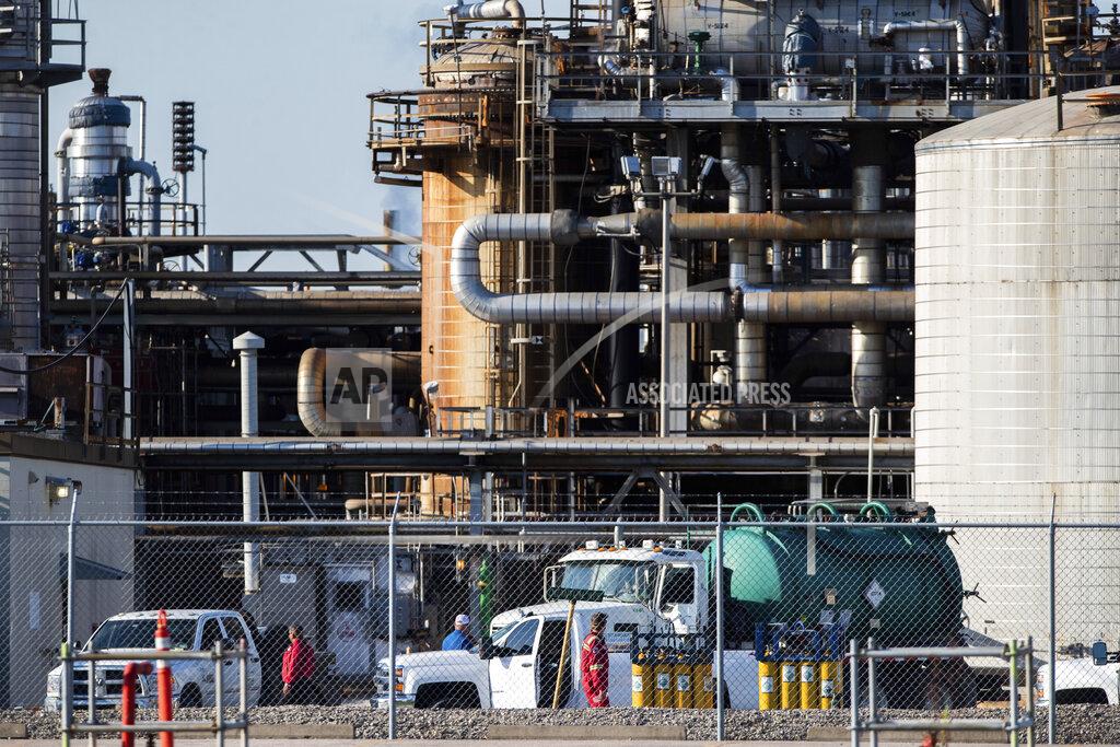 Marie D. De Jesús Workers stand in a lot at a LyondellBasell facility in La Porte, Texas Tuesday, July 27, 2021. An explosion Tuesday evening killed two people at the facility and left several others injured. (Mark Mulligan/Houston Chronicle via AP)