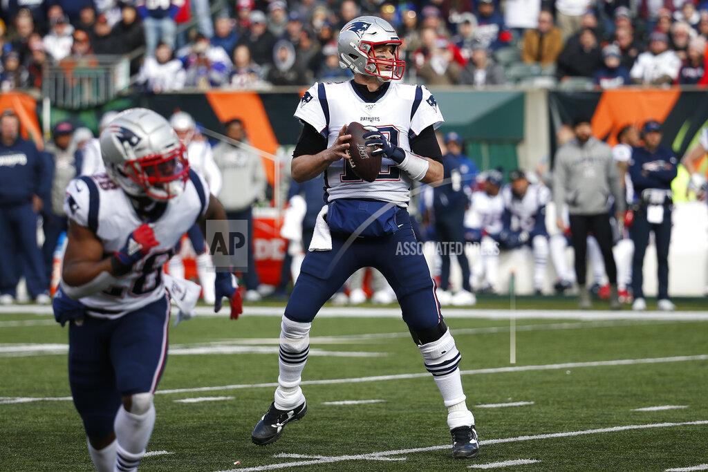 Frank Victores New England Patriots quarterback Tom Brady (12) looks to pass before throwing for a touchdown in the first half of an NFL football game against the Cincinnati Bengals, Sunday, Dec. 15, 2019, in Cincinnati. With this touchdown pass Brady surpasses Peyton Manning for the most seasons with 20+ touchdown passes in NFL history. (AP Photo/Frank Victores)