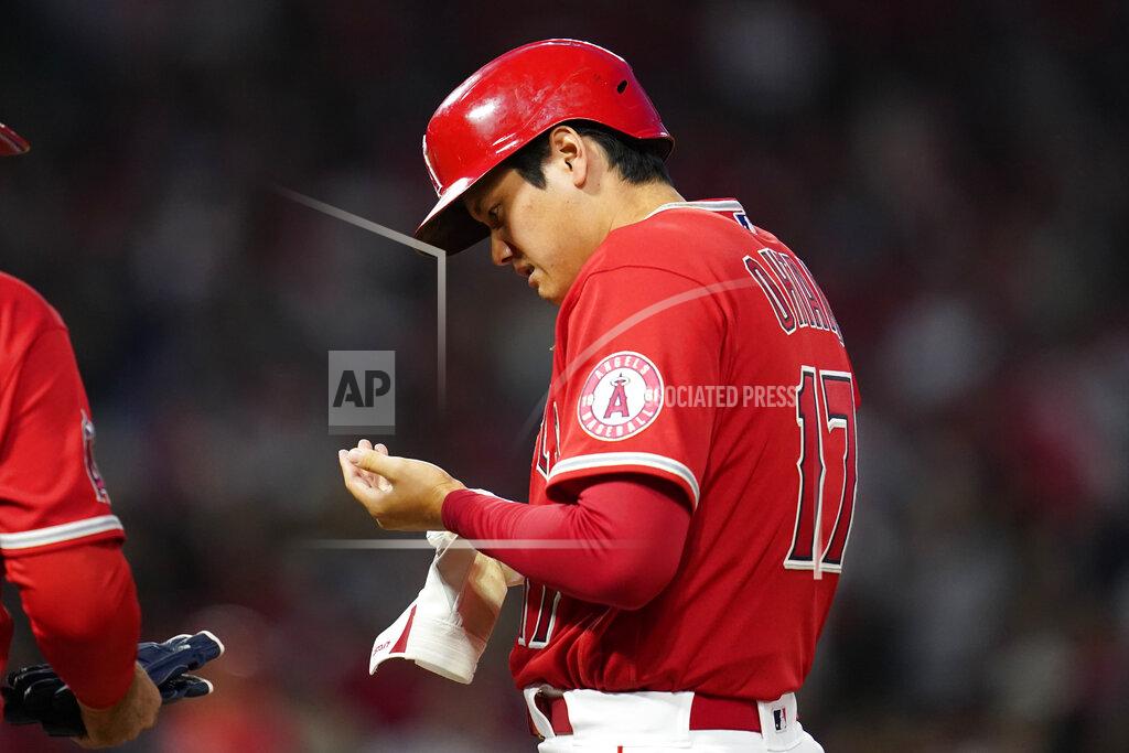 Ashley Landis Los Angeles Angels designated hitter Shohei Ohtani (17) looks at his left hand after running to first base on a single during the fourth inning of a baseball game against the Tampa Bay Rays in Anaheim, Calif., Tuesday, May 10, 2022. (AP Photo/Ashley Landis)