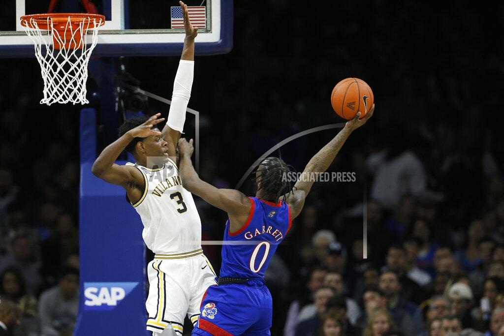 Matt Slocum Kansas's Marcus Garrett (0) goes up for a shot against Villanova's Brandon Slater (3) during the first half of an NCAA college basketball game, Saturday, Dec. 21, 2019, in Philadelphia. (AP Photo/Matt Slocum)