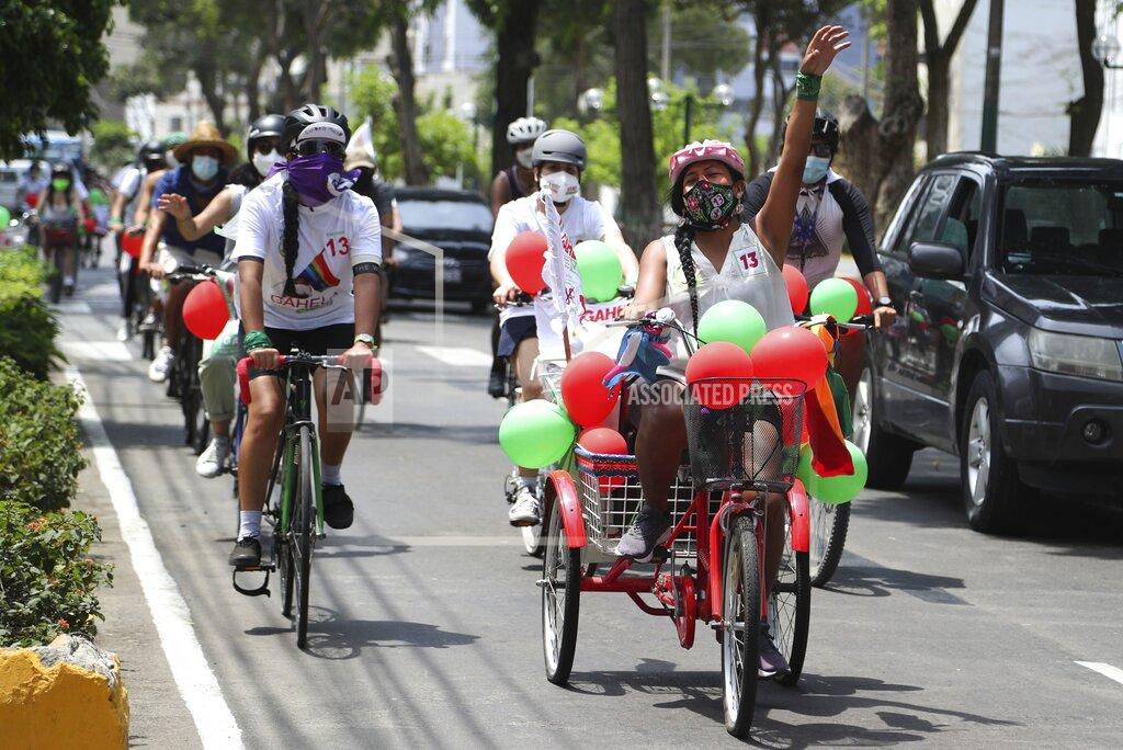 Martin Mejia Together for Peru party transgender congressional candidate Gahela Cari, leads a bicycle caravan as she campaigns in Lima, Peru, Sunday, March 28, 2021. This is the second time in as many years that Cari runs for Congress, following those of two other trans women's unsuccessful attempts over a decade ago. (AP Photo/Martin Mejia)