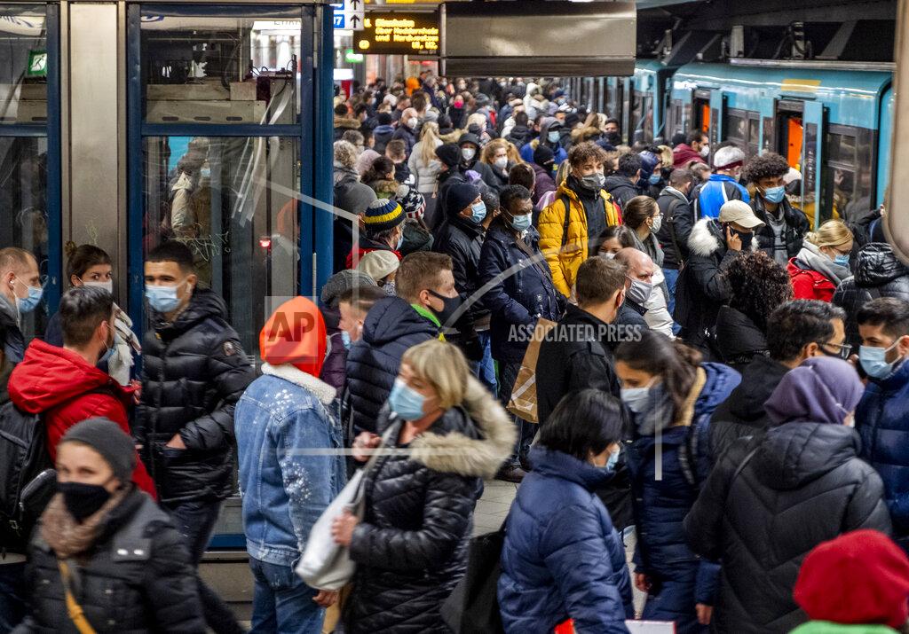 Michael Probst People wear face masks but stand close together as they wait for a subway train in Frankfurt, Germany, Wednesday, Dec. 2, 2020. (AP Photo/Michael Probst)