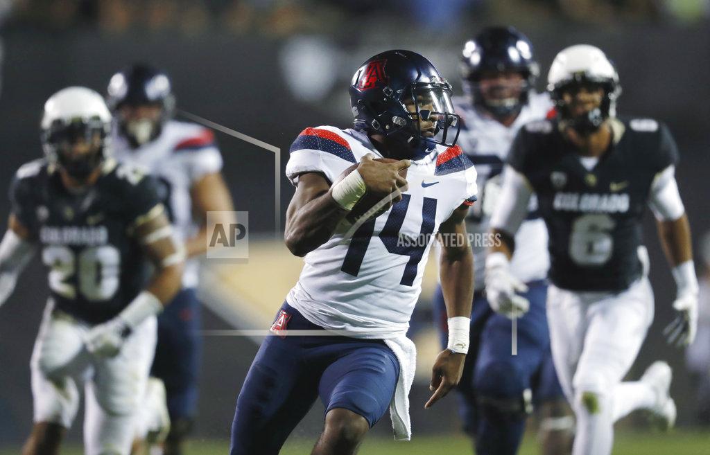 David Zalubowski FILE - In this Oct. 7, 2017, file photo, Arizona quarterback Khalil Tate runs for a touchdown past Colorado linebacker Drew Lewis, back left, and defensive back Evan Worthington in the second half of an NCAA college football game, in Boulder, Colo. Colorado is hoping to contain Tate after the Arizona quarterback set an FBS record with 327 yards rushing last season. (AP Photo/David Zalubowski, File)
