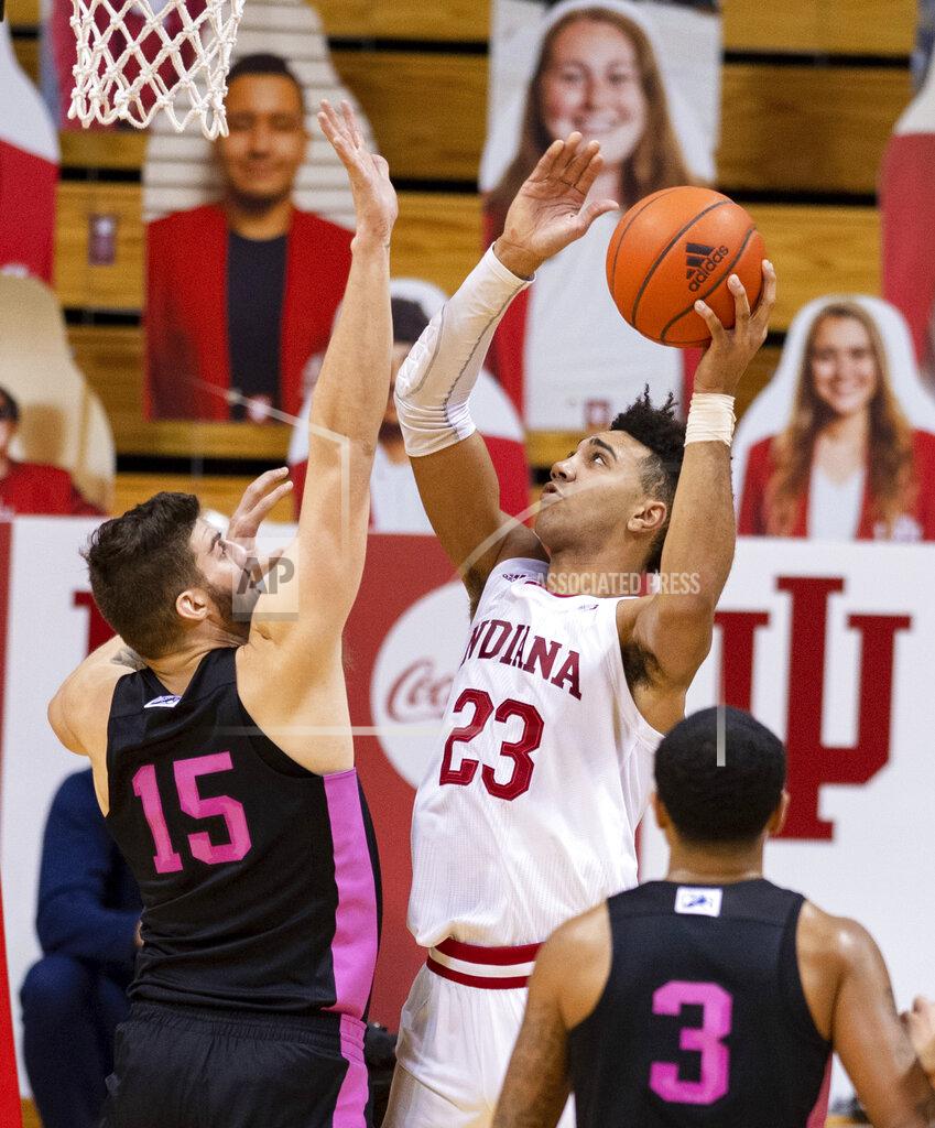 Doug Mcschooler Indiana forward Trayce Jackson-Davis (23) puts up a shot as he's defended by Penn State forward Trent Buttrick (15) during the first half of an NCAA college basketball game, Wednesday, Dec. 30, 2020, in Bloomington, Ind. (AP Photo/Doug McSchooler)