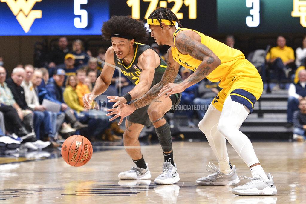 William Wotring West Virginia forward Jalen Bridges (11) steals the ball from Baylor guard Kendall Brown (2) during the first half of an NCAA college basketball game in Morgantown, W.Va., Tuesday, Jan. 18, 2022. (William Wotring)