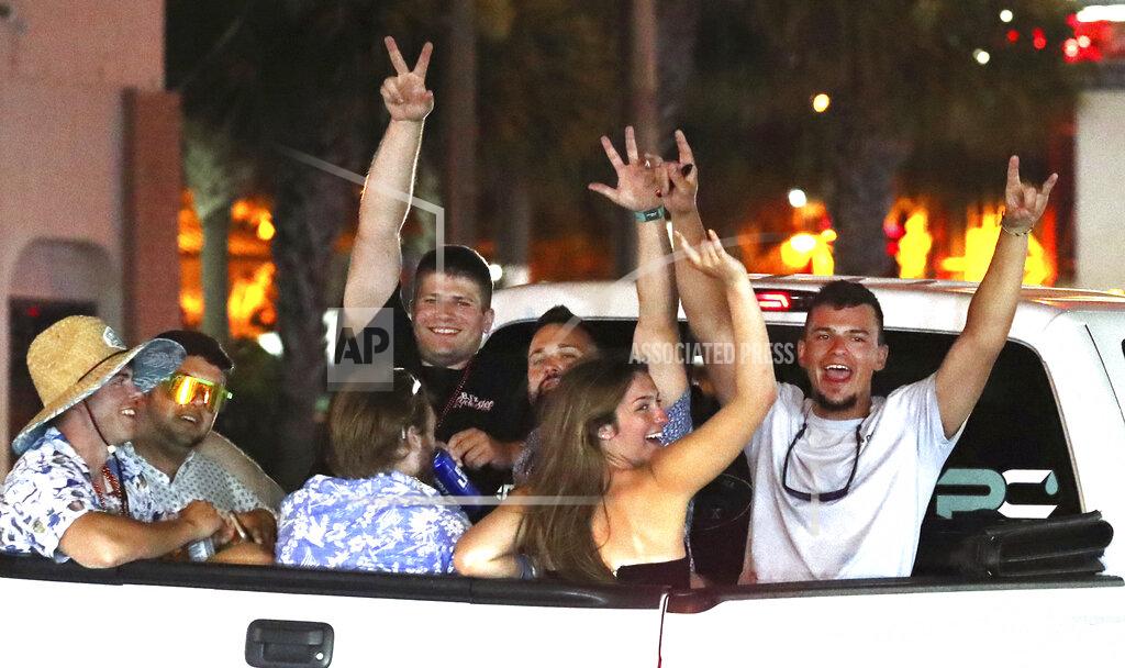David Tucker In this June 12, 2021 photo, Daytona Truck Meet, enthusiasts pack Atlantic Avenue and sidewalk near the Ocean Center, in Daytona Beach, Fla. (David Tucker/The Daytona Beach News-Journal via AP)