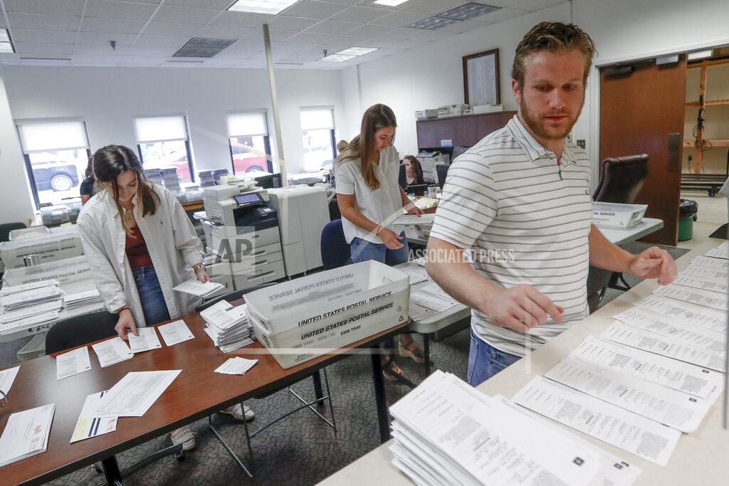 Keith Srakocic Processing work on mail in ballots for the Pennsylvania Primary election is being done by Emily Pellegrino, left, Danielle Beardsley, center, and Tim Vernick at the Butler County Bureau of Elections, Thursday, May 28, 2020, in Butler, Pa. Some county and state officials are warning that a flood of mailed-in ballots in Pennsylvania, fueled by fears of in-person voting during the coronavirus pandemic, will create a number of problems in Tuesday's primary election that must be fixed before they cause a disaster in this battleground state in November's presidential election. (AP Photo/Keith Srakocic)