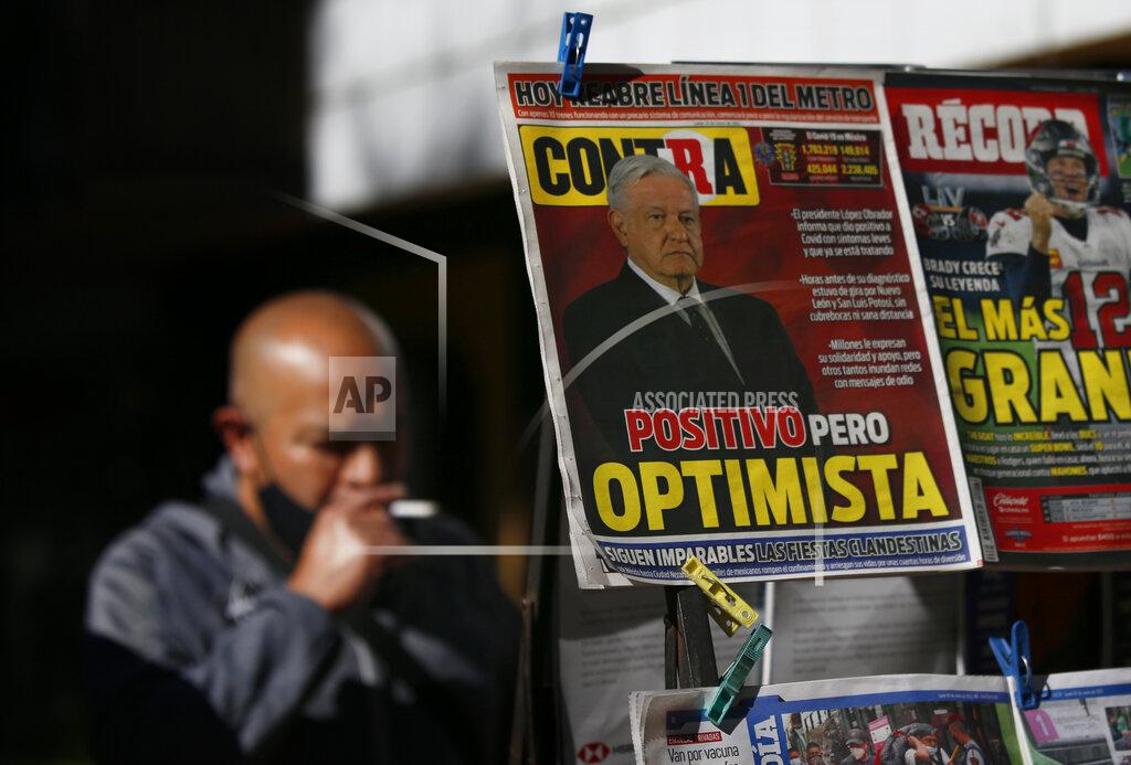 Marco Ugarte A newspaper's front page carries the Spanish headline "Positive but optimistic" for the story about Mexican President Andrés Manuel López Obrador having COVID-19 at a kiosk on Paseo de la Reforma in Mexico City, Monday, Jan. 25, 2021. López Obrador was working from isolation on Monday, Jan. 25, 2021, a day after announcing that he had tested positive for COVID-19, his interior secretary said. (AP Photo/Marco Ugarte)