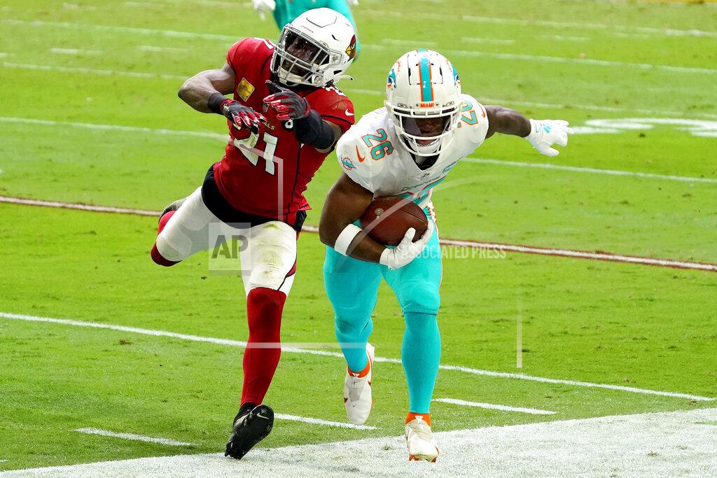 Rick Scuteri Miami Dolphins running back Salvon Ahmed (26) is knocked out of bounds by Arizona Cardinals cornerback Patrick Peterson (21) during the first half of an NFL football game, Sunday, Nov. 8, 2020, in Glendale, Ariz. (AP Photo/Rick Scuteri)