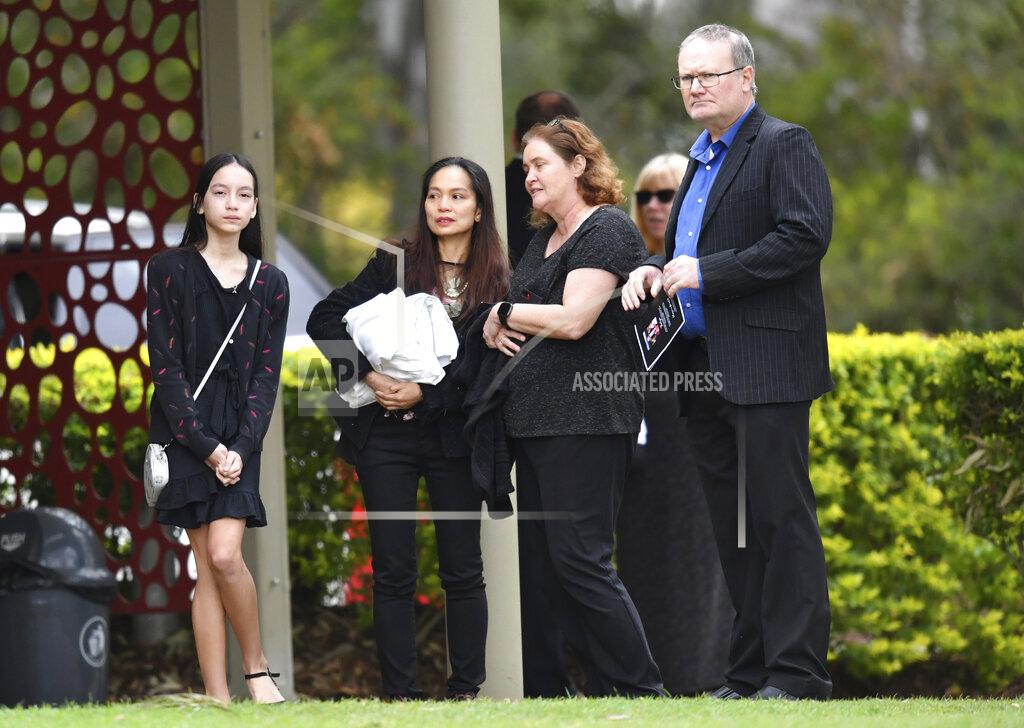 Darren England Family and friends of Bernard Prendergast attend his funeral in Brisbane, Thursday, Sept. 10, 2020. Prendergast's daughter, Sarah Caisip was refused permission to go to the funeral because she was forced to spend 14 days in hotel quarantine. (Darren England/AAP Image via AP)