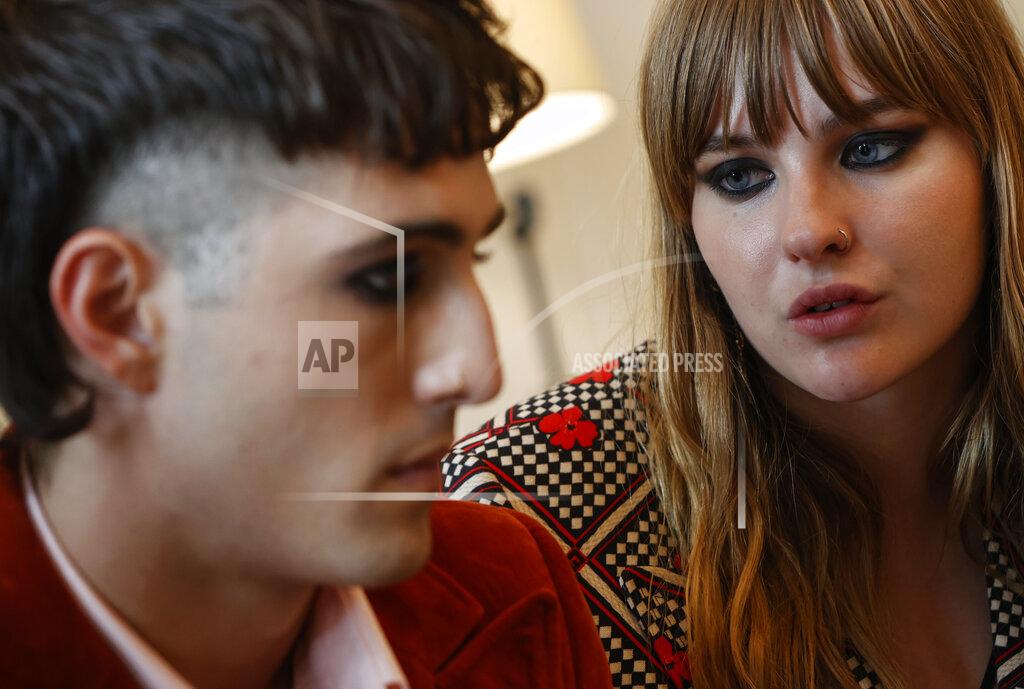 Riccardo De Luca Victoria De Angelis, bass player of Italian band Maneskin band, winners of the Eurovision Song Contest in May, looks at frontman Damiano David, left, during an interview with the Associated Press at a hotel in Rome, Tuesday, July 27, 2021. (AP Photo/Riccardo De Luca)