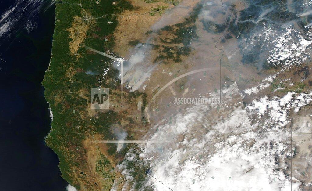 Uncredited This satellite image provided by Satellite image ©2021 Maxar Technologies shows overview of wildfires from Oregon, Idaho, and Northern California on Sunday, July 18, 2021. Extremely dry conditions and heat waves tied to climate change have made wildfires harder to fight. Climate change has made the West much warmer and drier in the past 30 years and will continue to make weather more extreme and wildfires more frequent and destructive. (Satellite image ©2021 Maxar Technologies via AP)