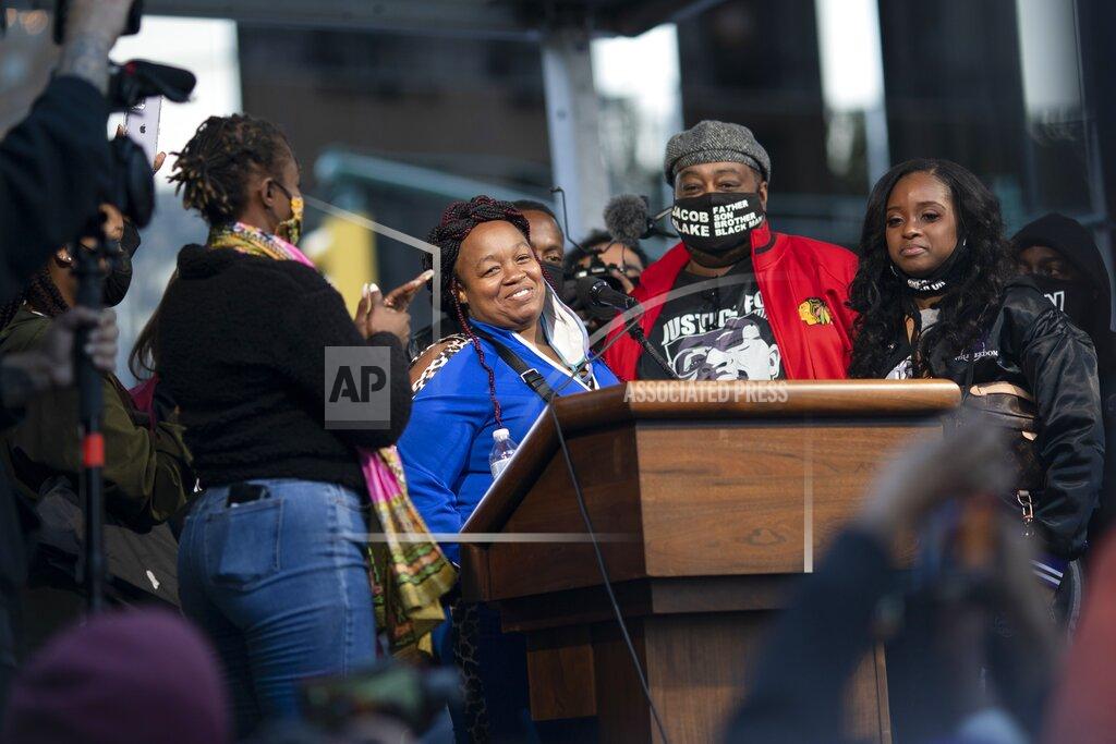 Wong Maye-E Tamika Palmer, center, the mother of Breonna Taylor, stands on stage during the "State of Emergency" rally calling for justice in Taylor's shooting, Saturday, Oct. 17, 2020, in New York. (AP Photo/Wong Maye-E)