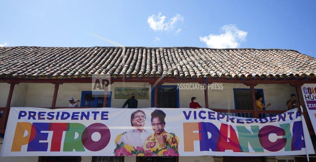 Fernando Vergara Supporters of Historical Pact coalition presidential candidate Gustavo Petro, hold an electoral banner of Petro and his running mate Francia Marquez during a closing campaign rally in Zipaquira, Colombia, Sunday, May 22, 2022. Elections are set for May 29. (AP Photo/Fernando Vergara)