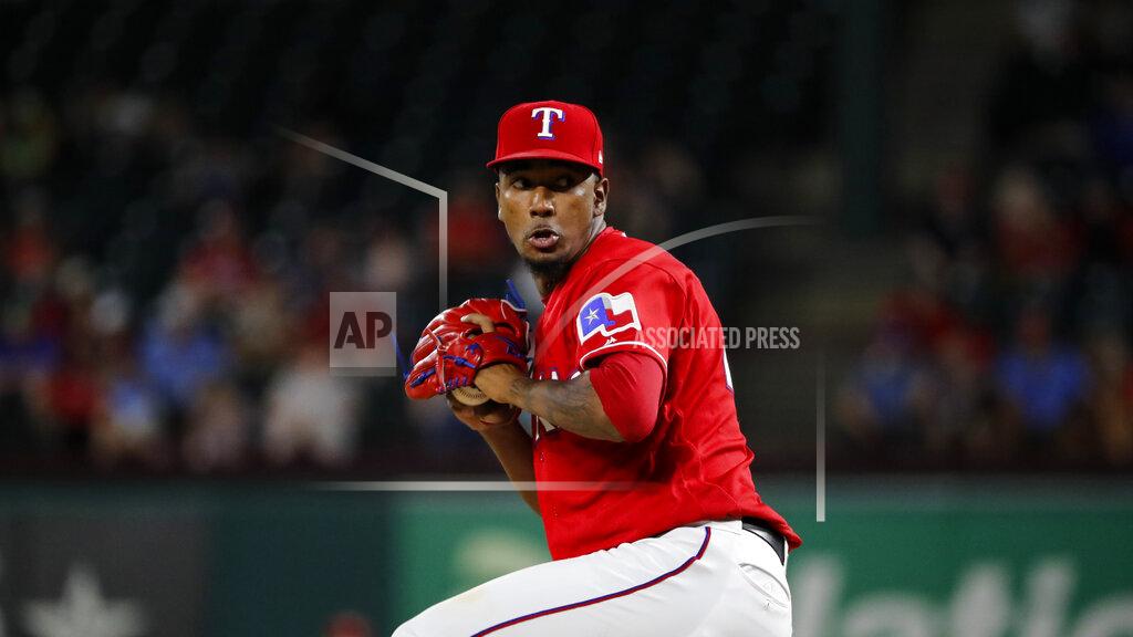 In this Sept. 24, 2019 photo Texas Rangers relief pitcher Emmanuel Clase works against the Boston Red Sox in a baseball game in Arlington, Texas. Clase has been suspended 80 games by Major League Baseball for testing positive for a banned performance-enhancing drug Friday, May 1, 2020.. (AP Photo/Tony Gutierrez)
