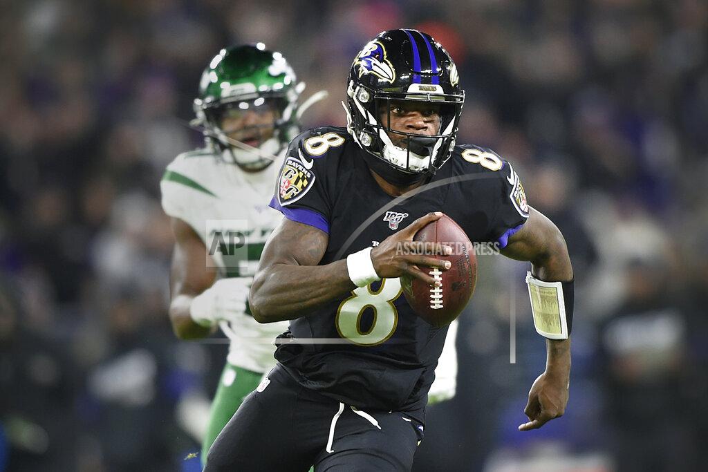 Gail Burton FILE - In this Dec. 12, 2019, file photo, Baltimore Ravens quarterback Lamar Jackson (8) runs with the ball as New York Jets outside linebacker Brandon Copeland (51) chases him during the first half of an NFL football game, in Baltimore. The Ravens bring a 12-game winning streak into their playoff matchup with the Tennessee Titans in Saturday night.(AP Photo/Gail Burton, File)