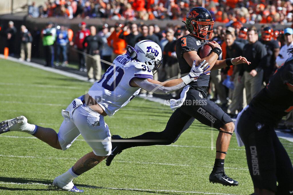 Sue Ogrocki TCU linebacker Garret Wallow (30) chases Oklahoma State quarterback Spencer Sanders (3) in the first half of an NCAA college football game in Stillwater, Okla., Saturday, Nov. 2, 2019. (AP Photo/Sue Ogrocki)