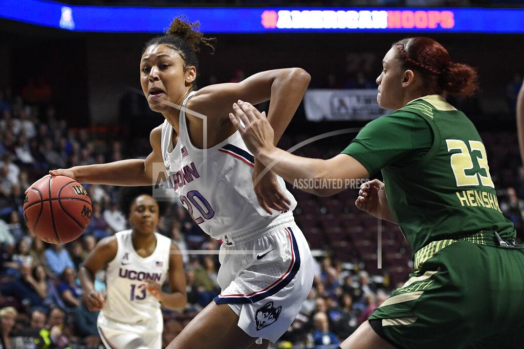 Jessica Hill FILE - Connecticut's Olivia Nelson-Ododa, left, drives around South Florida's Tamara Henshaw during the first half of an NCAA college basketball game in the American Athletic Conference tournament semifinals at Mohegan Sun Arena, Sunday, March 8, 2020, in Uncasville, Conn. UConn officials have discussed creating helmet stickers, warm-up T-shirts and altering athletic uniforms in other ways to show support for the Black Lives Matter movement. “I believe as athletes that we have this platform, especially here, we have a platform and a voice and we should use it, especially on topics like this that have been going on for hundreds of years," center Olivia Nelson-Ododa said last month. "And so the ability to speak out about it and advocating for the Black Lives Matter movement is very important to me, and I know for the rest of my team as well.” (AP Photo/Jessica Hill, File)