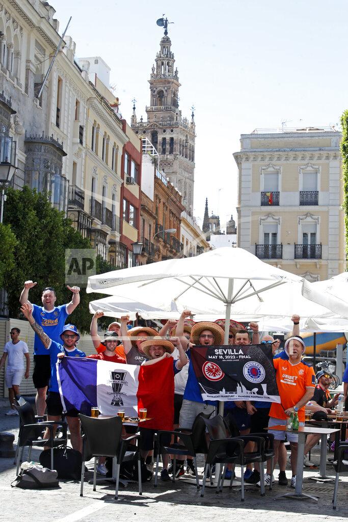 Angel Fernandez Glasgow Rangers supporters cheer outside a bar in downtown Seville, Spain, Tuesday, May 17, 2022. Eintracht Frankfurt will play Glasgow Rangers in the Europa League final Wednesday evening in Seville. (AP Photo/Angel Fernandez)