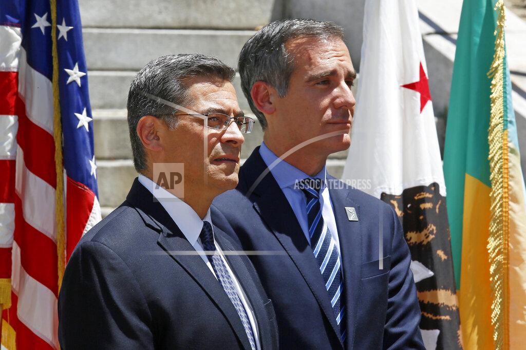 Damian Dovarganes FILE - In this May 4, 2018, file photo, California Attorney General Xavier Becerra, left, stands with Los Angeles Mayor Eric Garcetti at a news conference in Los Angeles. Garcetti has taken his name out of consideration for a possible post in the Biden administration. (AP Photo/Damian Dovarganes, File)