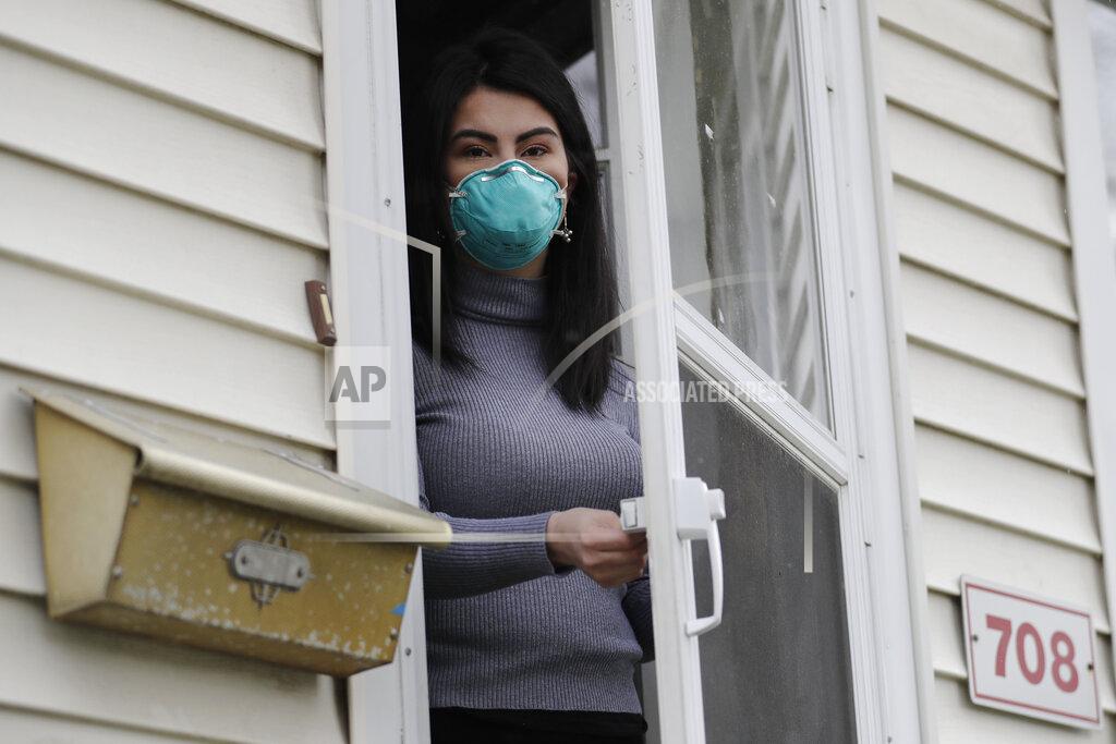 Nam Y. Huh Francy Sandoval poses for a portrait at her home in Melrose Park, Ill., Thursday, April 23, 2020. She works as a receptionist at a community health clinic which treats multiple COVID-19 cases. She has to isolate herself in the attic as soon as she comes home from work each day and is terrified of infecting her family. (AP Photo/Nam Y. Huh)