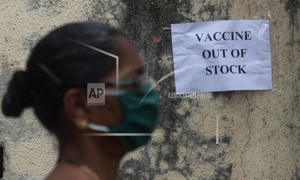Rafiq Maqbool A woman wearing mask walks past a notice about the shortage of coronavirus (COVID-19) vaccine supply outside a vaccination centre in Mumbai, India, Thursday, April 8, 2021. India started its vaccination drive in January. So far, more than 90 million Indians above 45 and health workers have received at least one shot and only 11 million of them have got both. (AP Photo/Rafiq Maqbool)
