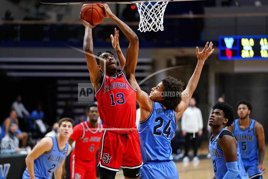 Matt Slocum St. John's Isaih Moore (13) goes up for a shot against Villanova's Jeremiah Robinson-Earl (24) during the second half of an NCAA college basketball game, Tuesday, Feb. 23, 2021, in Villanova, Pa. (AP Photo/Matt Slocum)