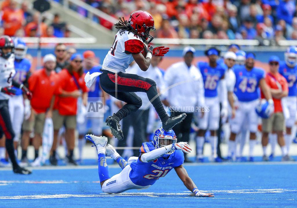Steve Conner San Diego State wide receiver BJ Busbee, in the air, avoids the tackle attempt by Boise State safety Tyreque Jones, on the ground, in the first half of an NCAA college football game, Saturday, Oct. 6, 2018, in Boise, Idaho. (AP Photo/Steve Conner)