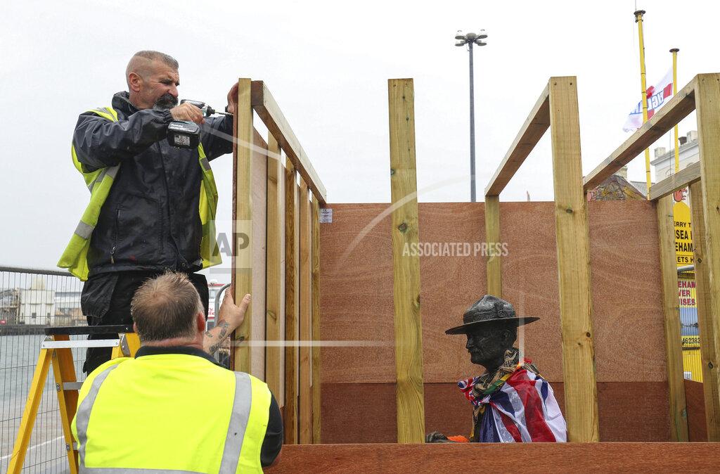 Andrew Matthews The statue of the Scouting Movement Robert Baden-Powell is boarded up by the local council, in Poole Quay, England, Friday June 12, 2020. The council has announced that the statue of Baden-Powell would be temporarily taken down as it is believed to be a target for protests. In the UK the Black Lives Matter movement has prompted a wider debate about issues relating to Britain's colonial past and historical figures. (Andrew Matthews/PA via AP)