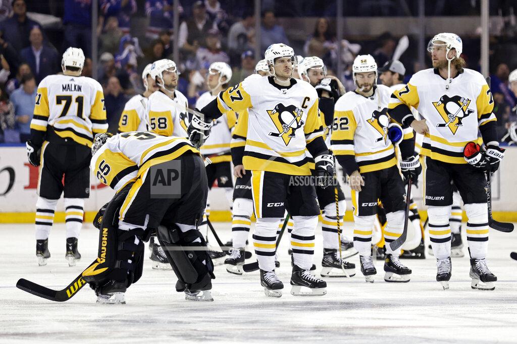 Adam Hunger Pittsburgh Penguins center Sidney Crosby (87) watches as the New York Rangers celebrate a game winning goal by Artemi Panarin during overtime in Game 7 of an NHL hockey Stanley Cup first-round playoff series Sunday, May 15, 2022, in New York. The Rangers won 4-3 in overtime. (AP Photo/Adam Hunger)