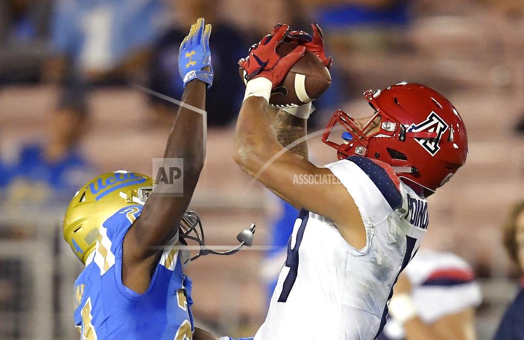 Mark J. Terrill Arizona wide receiver Shawn Poindexter, right, makes a catch as UCLA defensive back Jay Shaw defends during the second half of an NCAA college football game Saturday, Oct. 20, 2018, in Pasadena, Calif. UCLA won 31-30. (AP Photo/Mark J. Terrill)