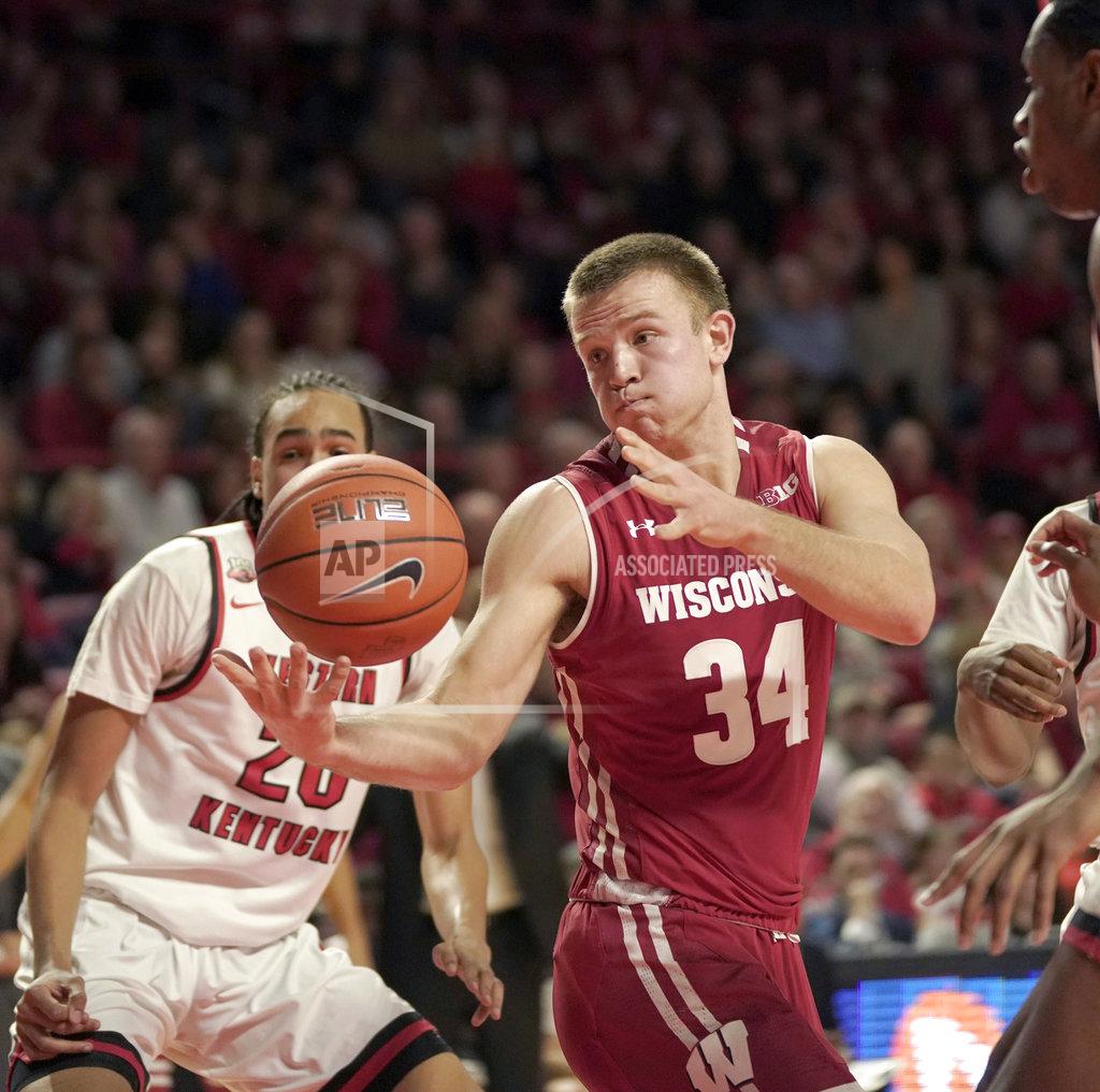 Tim Broekema Wisconsin guard Brad Davison (34) tries to hold on to the ball as Western Kentucky guard Dalano Banton (20) defends during the first half of an NCAA college basketball game Saturday, Dec. 29, 2018, in Bowling Green, Ky. (AP Photo/Tim Broekema)