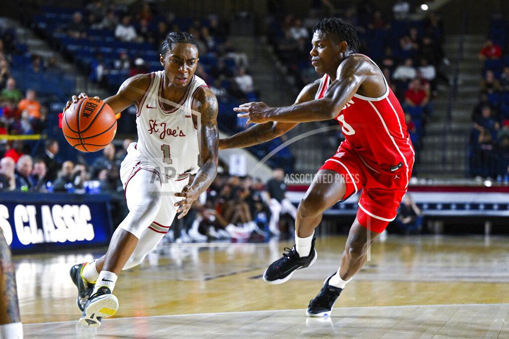 Terrance Williams Saint Joseph's guard Christian Winborne (1) drives to the basket against Houston guard Marcus Sasser during the second half of an NCAA college basketball game at the Veterans Classic, Friday, Nov. 11, 2022, in Annapolis, Md. (AP Photo/Terrance Williams)