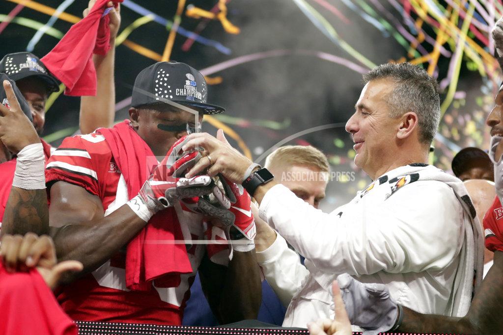Michael Conroy Ohio State's Terry McLaurin (83) kisses the trophy along side head coach Urban Meyer Sunday, Dec. 2, 2018, after defeating Northwestern in the Big Ten championship NCAA college football game, in Indianapolis. Ohio State won 45-24. (AP Photo/Michael Conroy)