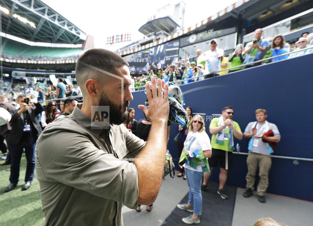 Ted S. Warren FILE - Seattle Sounders forward Clint Dempsey applauds supporters as he walks off the field, Saturday, Sept. 1, 2018, in Seattle, following a pre-match ceremony in his honor after he announced his retirement from professional soccer. Four years removed from playing, Dempsey is set to be inducted into the U.S. National Soccer Hall of Fame on Saturday, May 21, 2022. (AP Photo/Ted S. Warren, File)