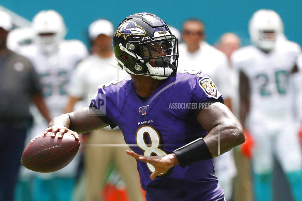 Wilfredo Lee FILE - In this Sunday, Sept. 8, 2019, file photo, Baltimore Ravens quarterback Lamar Jackson (8) looks to pass during the first half at an NFL football game against the Miami Dolphins in Miami Gardens, Fla. Jackson, Heisman Trophy owner (2016), meets Kyler Murray, who took that award last season on Sunday when the Ravens host the Arizona Cardinals. (AP Photo/Wilfredo Lee, File)
