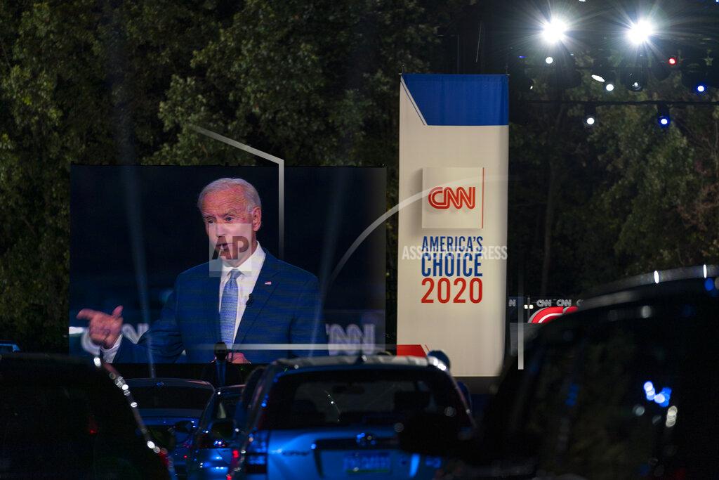 Carolyn Kaster Audience members watch from their cars as Democratic presidential candidate former Vice President Joe Biden, seen on a monitor, speaks during a CNN town hall in Moosic, Pa., Thursday, Sept. 17, 2020. (AP Photo/Carolyn Kaster)
