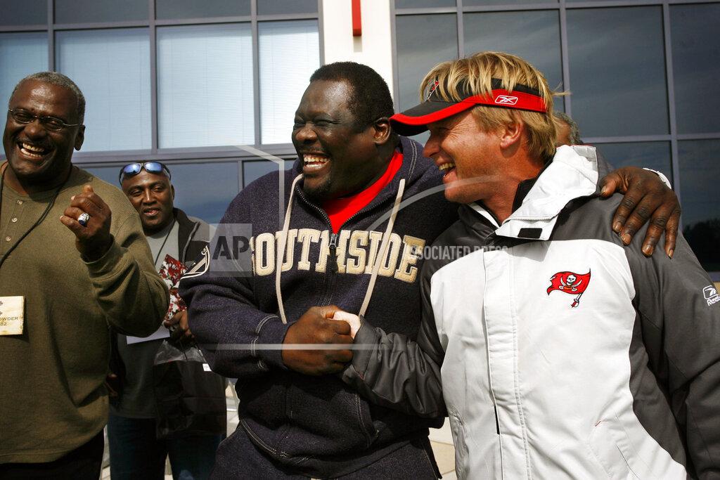 Carrie Pratt In this Dec. 8, 2006, photo, former Tampa Bay Buccaneers NFL football player David Lewis shakes hands while joking with Tampa Bay Buccaneers head coach Jon Gruden, right, after a Bucs practice in Tampa, Fla. Former Bucs nose tackle Randy Crowder is at far left. Former Bucs defensive player Johnny Ray Smith is at rear, second from left. Lewis, a key member of the Tampa Bay Buccaneers’ 1979 team that reached the NFC title game, has died. He was 65. Lewis died Tuesday, July 14, 2020, in Tampa. The cause was not immediately known, but he had struggled with health issues in recent years, according to Southern California, where he played in college. (Carrie Pratt/Tampa Bay Times via AP)
