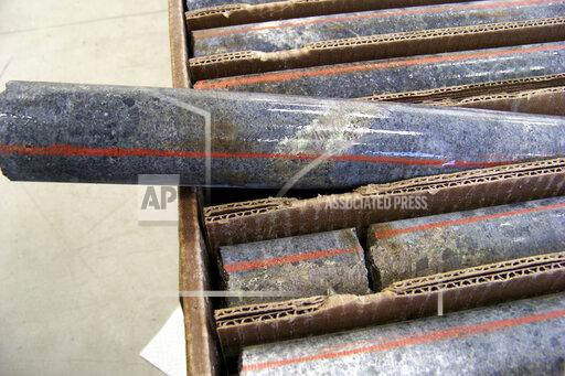 FILE - In this Oct. 4, 2011, file photo, a core sample drilled from underground rock near Ely, Minn., shows a band of shiny minerals containing copper, nickel and precious metals, center, that Twin Metals Minnesota LLC, hopes to mine near the Boundary Waters Canoe Area Wilderness in northeastern Minnesota. The Biden administration ordered a study Wednesday, Oct. 20,2021, that could lead to a 20-year ban on mining upstream from the wilderness. (AP Photo/Steve Karnowski, File)