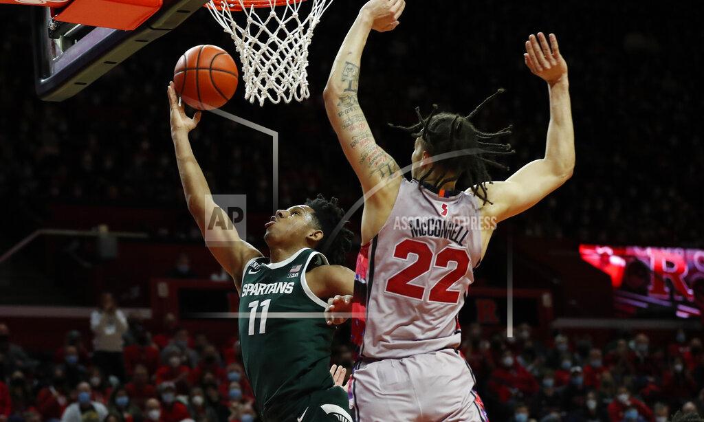 Noah K. Murray Michigan State guard A.J. Hoggard (11) drives to the basket against Rutgers guard Caleb McConnell (22) during the first half of an NCAA college basketball game in Piscataway, N.J., Saturday, Feb. 5, 2022. (AP Photo/Noah K. Murray)