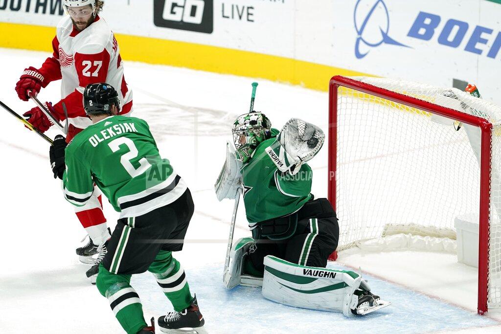 Tony Gutierrez Detroit Red Wings center Michael Rasmussen (27) and Dallas Stars' Jamie Oleksiak (2) watch as Stars goaltender Anton Khudobin, right, gloves the puck during the third period of an NHL hockey game in Dallas, Tuesday, Jan. 26, 2021. (AP Photo/Tony Gutierrez)