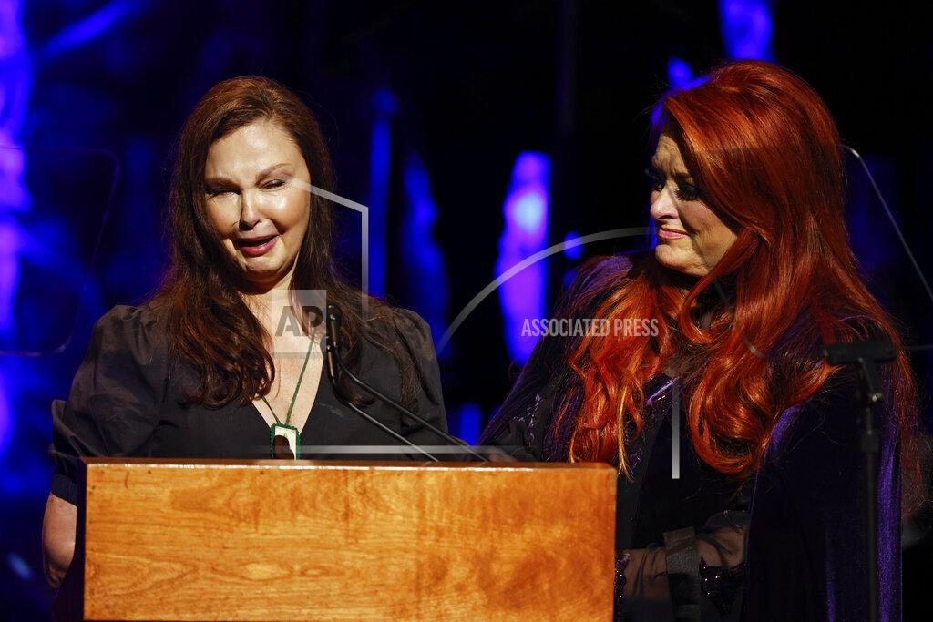 Wade Payne Ashley Judd, left, cries as she speaks while sister Wynonna Judd listens during the Country Music Hall of Fame Medallion Ceremony Sunday, May 1, 2022, in Nashville, Tenn. (Photo by Wade Payne/Invision/AP)