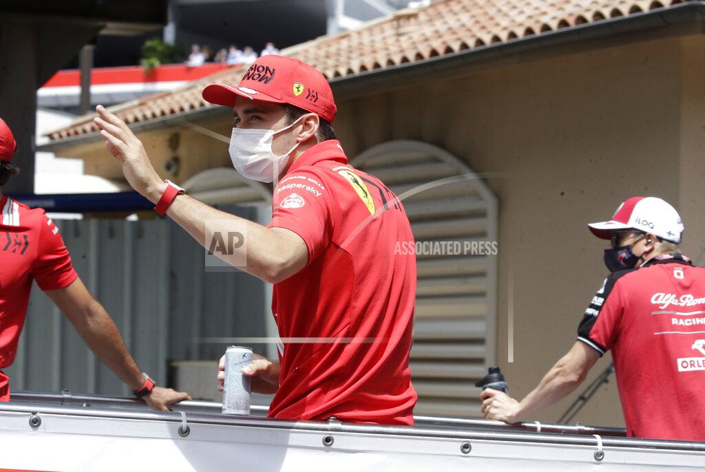 Luca Bruno Ferrari driver Charles Leclerc of Monaco waves during the drivers parade prior to the Monaco Grand Prix at the Monaco racetrack, in Monaco, Sunday, May 23, 2021. (AP Photo/Luca Bruno)