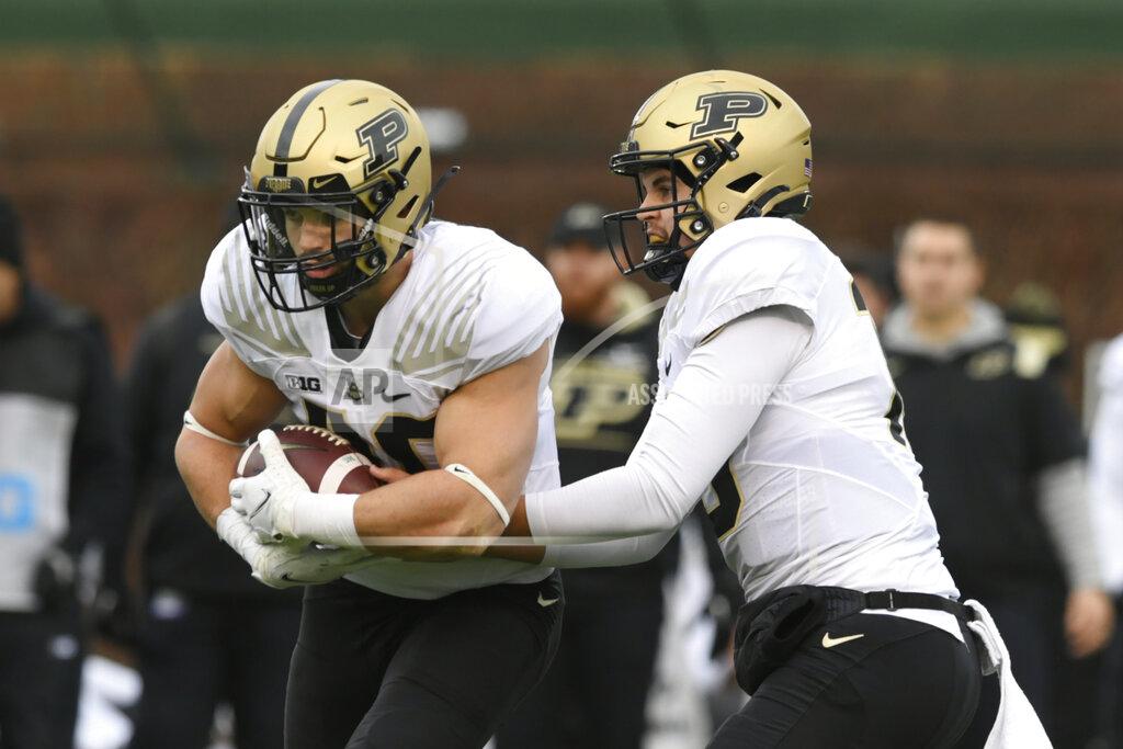 Paul Beaty Purdue quarterback Aidan O'Connell (16) hands off to running back Zander Horvath (40) during the second half of an NCAA college football game against Northwestern, on Saturday, Nov. 20, 2021 at Wrigley Field in Chicago. Purdue won 32-14. (AP Photo/Paul Beaty)