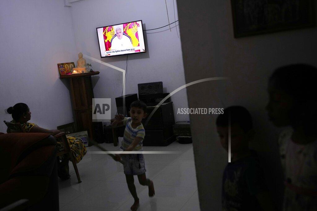 Eranga Jayawardena A family watches a telecast speech of Sri Lankan Prime Minister Ranil Wickeremesinghe in Colombo, Sri Lanka, Monday, May 16, 2022. Sri Lanka’s prime minister on Monday proposed to privatize the country’s loss-making national carrier as part of reforms to solve the country worst economic crisis in recent memory. (AP Photo/Eranga Jayawardena)
