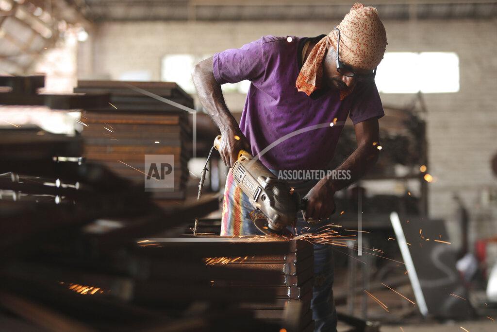Channi Anand An Indian worker prepares steel furniture at a factory on the outskirts of Jammu, India, Saturday, Sept.26, 2020. Millions of distressed Indian manufacturers and traders are counting on the eagerly-awaited October-December festive season to rescue them from their coronavirus catastrophe. But spending may be the last thing on the minds of many Indians who have lost their jobs or businesses in the pandemic downturn. India's pandemic assistance has amounted to only about 1% of its GDP, Nobel laureate Abhijit Banerjee said, compared with the U.S.'s package in March of about 10% of its GDP. (AP Photo/Channi Anand)