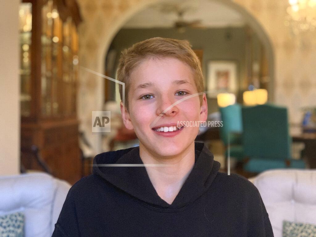 Kristin Drutchas This Monday, May 4, 2020 photo provided by his family shows Hudson Drutchas, 12, in his Chicago home. Drutchas is a sixth-grader and is, because he lives in a state that still has a stay-at-home order, is doing his schoolwork online. He says he feels like he's missing part of his childhood because of the global pandemic. (Kristin Drutchas via AP)
